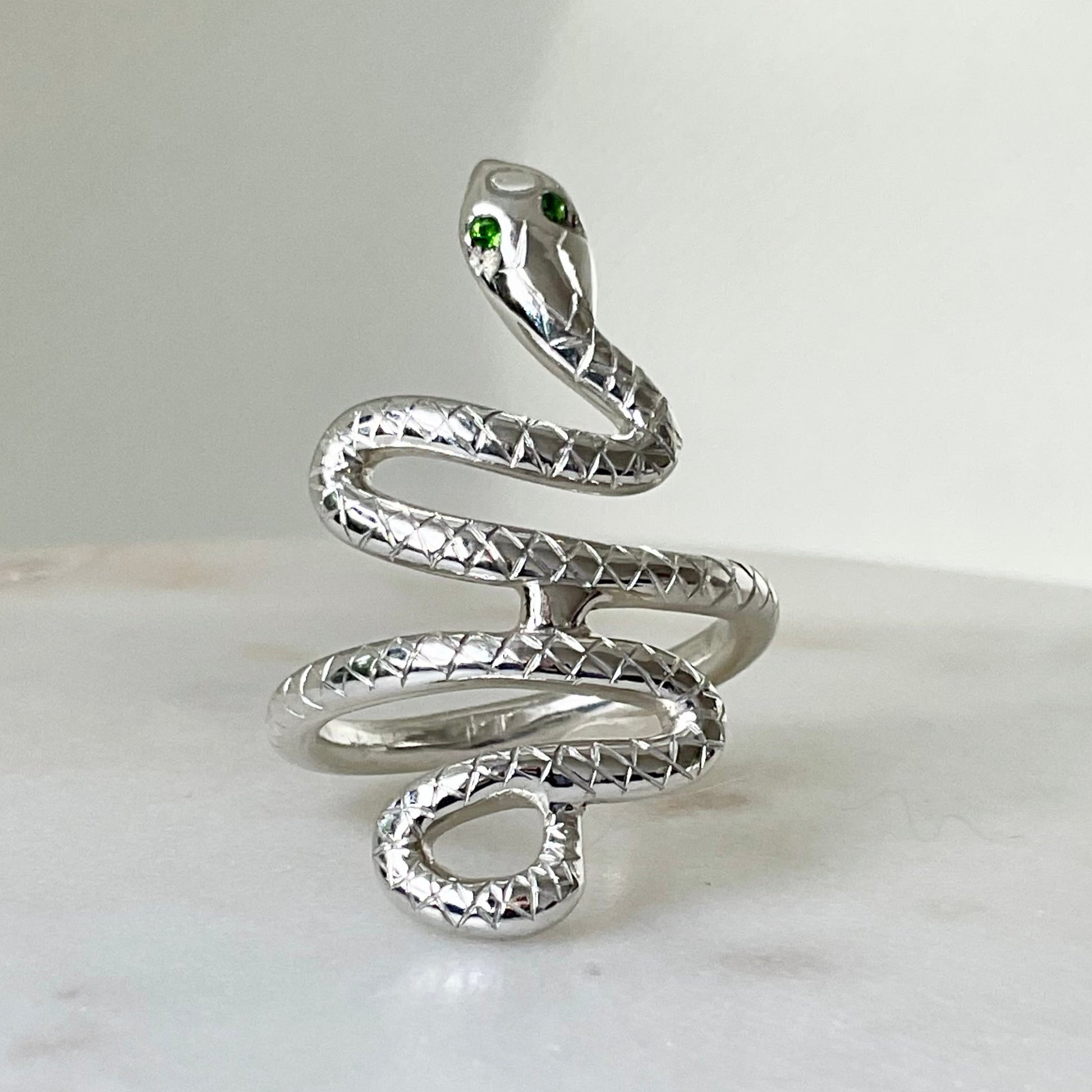 Sterling silver snake ring with green eyes