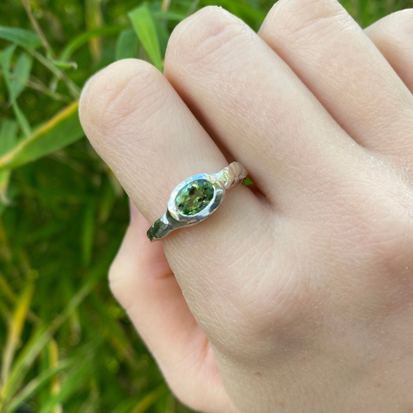 Oval green tourmaline ring in an organic, textured silver ring band