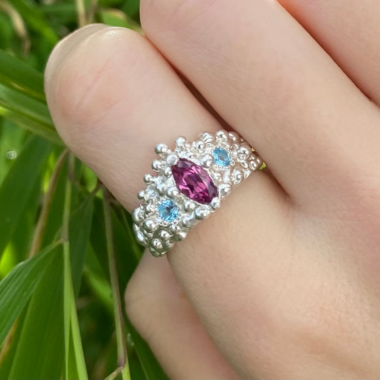 Jasmine ring with pink marquise garnet in a molten silver ring band