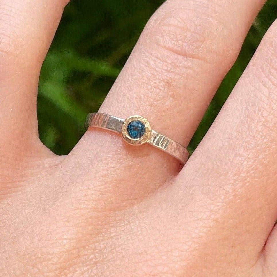 blue topaz ring shown on hand