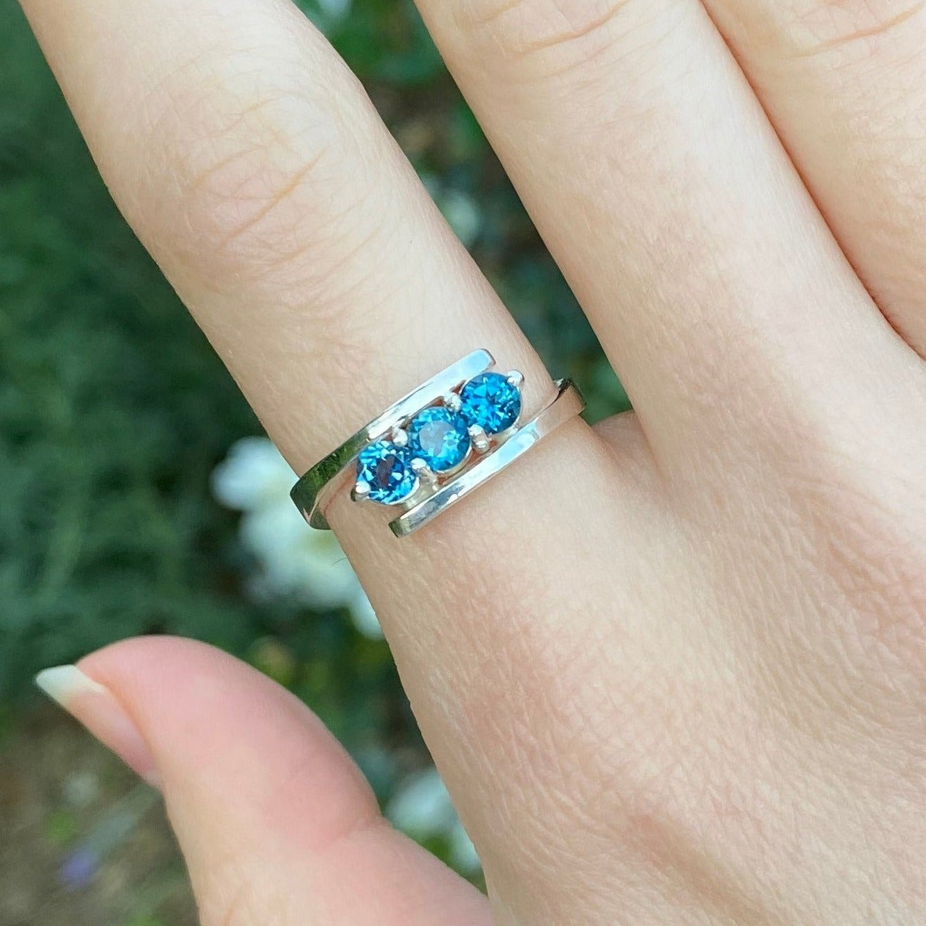 London blue topaz three stone ring shown on model