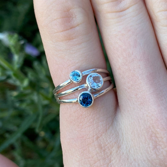 Blue and white topaz and blue zircon ring shown on model