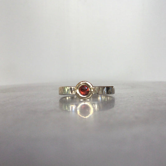 Mozambique garnet set in a 9ct gold bezel on a sterling silver ring