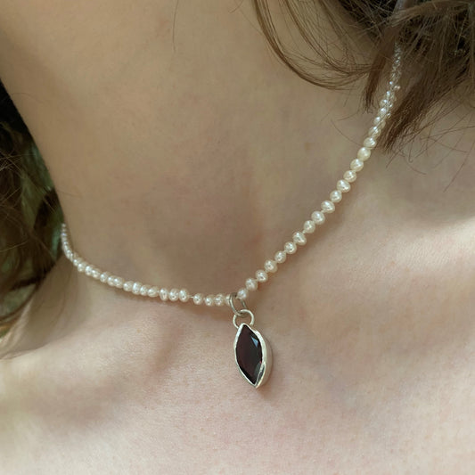 Garnet and peal choker shown on model